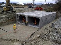 two men are standing in front of a building under construction