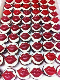 cupcakes with red and white frosting in the shape of heart shaped lips