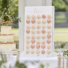 a wedding cake with cookies on it sitting in front of a sign that says, there's a treat