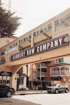 cars parked in front of a building with a sign that says canary row company on it