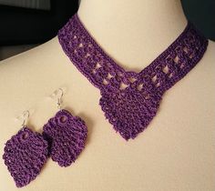 a purple crocheted necklace and matching earrings on a mannequin neckline