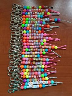 a bunch of colorful beads on a wooden table