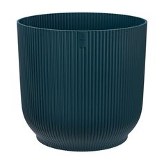 a large blue vase sitting on top of a white table