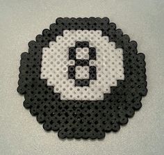 a black and white object with the letter e in it's center surrounded by dots