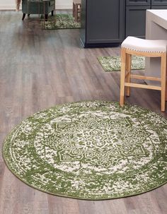 a green and white rug in the middle of a kitchen