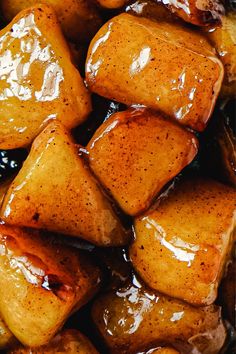 some food that is sitting on top of a pan with sauce in it and has been cut into cubes