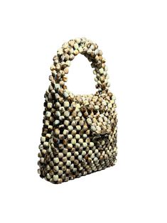 Artisan Beaded Handbag.Designed in NYC. Crafted with precision in the heart of Lagos, Nigeria.Elevate your style with our exquisite beaded handbags – a timeless accessory that seamlessly blends sophistication with versatility. Meticulously handcrafted, these bags are built to withstand the test of time. Whether paired with a cocktail dress, jeans and a tee, professional attire, or your favorite clubwear, our bead bags effortlessly complement any ensemble. Beaded Beige Shoulder Bag As Gift, Beaded Beige Bags For Everyday Use, Everyday Use Beige Beaded Bag, Natural Shoulder Bag With Pearl Handle For Everyday, Handmade Top Handle Bag, Beige Beaded Shoulder Bag For Gift, Chic Beaded Shoulder Bag For Daily Use, Beige Beaded Bag For Everyday Use, Natural Bag With Pearl Handle For Everyday Use