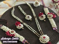 several necklaces and bracelets are arranged on a round plate with bead work