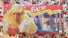 a barbie doll is shown in front of the box for her role as queen of the prom game