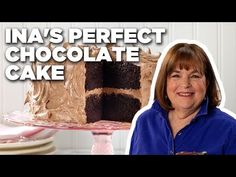 a woman standing in front of a cake with chocolate frosting on it and the words ina's perfect chocolate cake