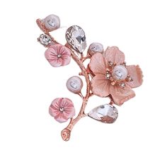 a brooch with pink flowers and pearls on it's side, against a white background