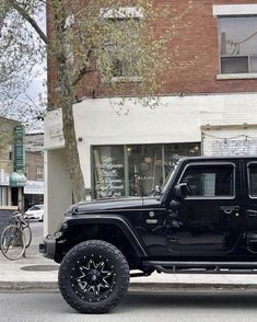 a black jeep is parked on the street