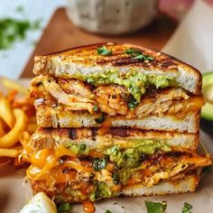 two grilled sandwiches stacked on top of each other with cheese and guacamole