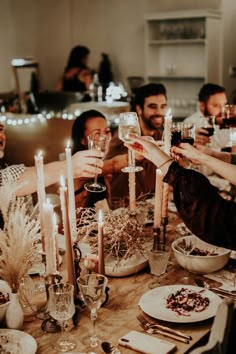 a group of people toasting with wine glasses