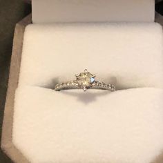 a diamond engagement ring in a box