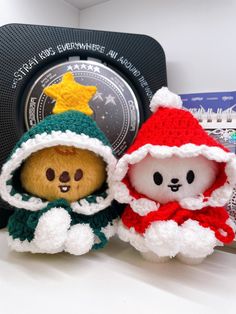 two teddy bears dressed as santa and snowman sitting next to each other in front of a clock