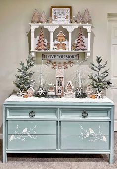 a blue dresser with christmas decorations on top