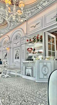 an ornately decorated kitchen with chandelier and white chairs in the middle of it