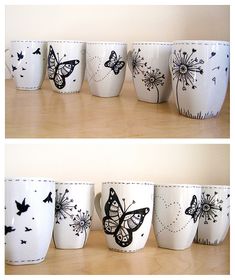 there are many cups that have butterflies painted on them