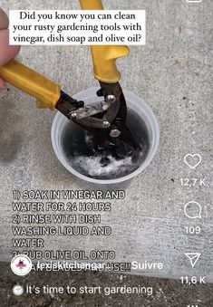 someone is using a pair of pliers to remove water from the floor in a bucket