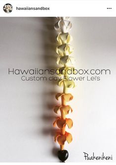 the hawaiian sandbox com custom day flower leis are made from paper and have hearts attached to them