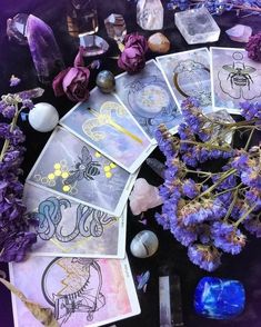 purple flowers, crystals and other items on a table