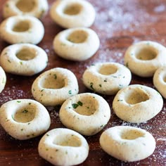 several small doughnuts on a wooden table