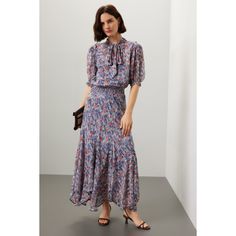 Blue floral cotton (100% Viscose). A-line. Short sleeves. Tie neck. Pull on. 53" from shoulder to hemline. Imported. Floral Print A-line Maxi Dress With Flowy Skirt, Floral Print A-line Flowy Maxi Dress, Flowy A-line Maxi Dress With Floral Print, Chic Blue Midi Dress With Ditsy Floral Print, Feminine Flowy Skirt Dress For Fall, Flowy Feminine Fall Dress, Fall Feminine Dress With Flowy Skirt, Spring Floral Print Fit And Flare Dress, Fall Floral Print Dress With Flowy Skirt