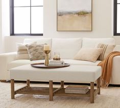 a living room with a white couch and coffee table