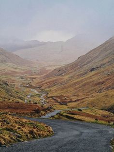 a winding road in the middle of mountains