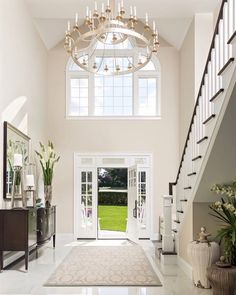 a large foyer with chandelier and white walls