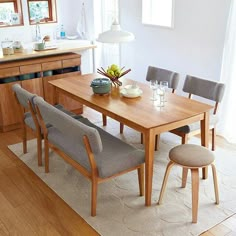 a dining room table with six chairs and an area rug in front of the table