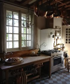 a kitchen with an oven, stove and table in it