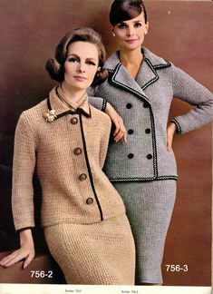 two women in dresses and jackets standing next to each other