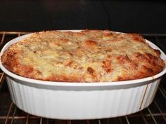 a casserole dish in the oven with cheese on top