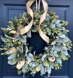 a blue door with a wreath on it and a bow hanging from the front door