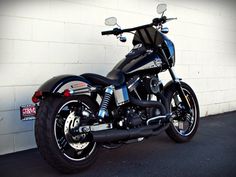 a motorcycle parked in front of a white wall