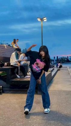 a woman standing next to a man on a skateboard