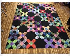 a black area rug with multicolored squares on it