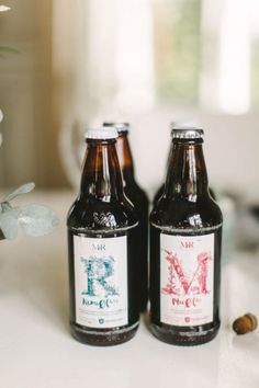 two bottles of beer sitting on top of a table