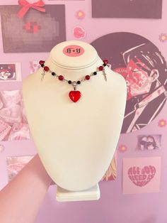 This choker is handmade, it has red and black beads and is connected by a transparent, red heart charm. You can get this choker/necklace with daggers or without! :) Emo Valentine's Day Choker Necklace, Alt Diys, Gothic Adjustable Choker For Valentine's Day, Red Heart Charm Choker Necklace, Gothic Heart-shaped Choker For Valentine's Day, Red Gothic Necklace With Heart Charm, Necklace With Heart, Heart Choker, Heart Chain