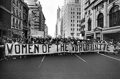 a crowd of people holding up a banner