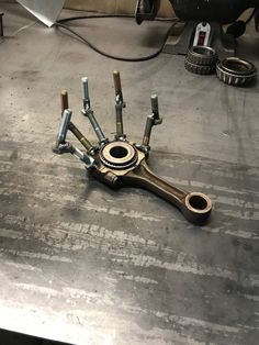 a group of tools sitting on top of a metal table next to a wrench