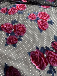 red roses on grey polka doted fabric with white dots and blue trimmings