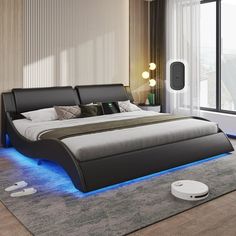 a modern bedroom with a large bed and blue lights on the headboard is shown