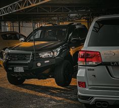 two cars parked next to each other in a parking lot