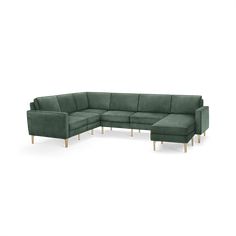 a green sectional couch with wooden legs and footrests on an isolated white background