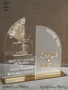 two clear glass awards with gold lettering on each one and an image of a camera