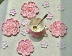 crocheted flower coasters and tea cup on a table