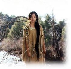 a woman in native dress standing next to trees and bushes with the words women of the earth on it